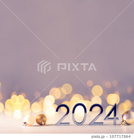 Metal numbers 2024 on table with bokeh lights. Metal numbers 2024 on table with bokeh lights. 107717864