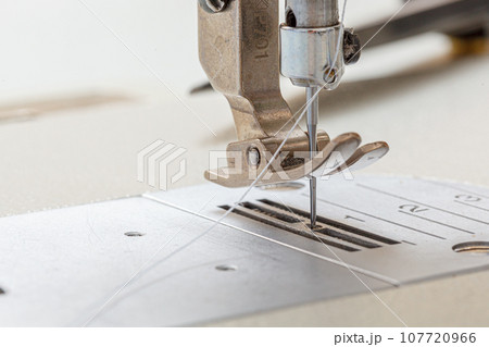 Sewing machine needle with thread and fabric 107720966