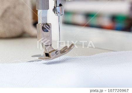 Sewing machine needle with thread and fabric 107720967