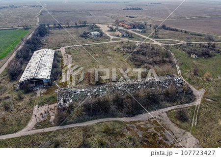 Abandoned farm, aerial view. Dilapidated industrial buildings. 107723427