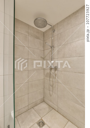 a shower with white tiles on the wall and green trim around the door, in a bathroom reurre a shower with white tiles on the wall and green trim around the door, in a bathroom reurre 107723927