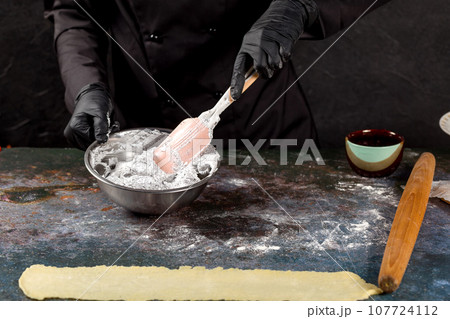 Confectioner mixes whipped egg whites with poppy seeds Confectioner mixes whipped egg whites with poppy seeds 107724112