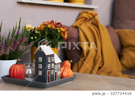 Cozy Place to Relax on Balcony or Terrace with Cute Autumn Hygge Home Decor and Blooming Flowers. Cozy Place to Relax on Balcony or Terrace with Cute Autumn Hygge Home Decor and Blooming Flowers. 107724416