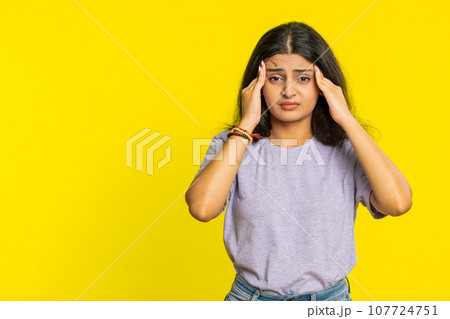 Indian woman rubbing temples to cure headache problem, suffering from tension, migraine stress pain 107724751