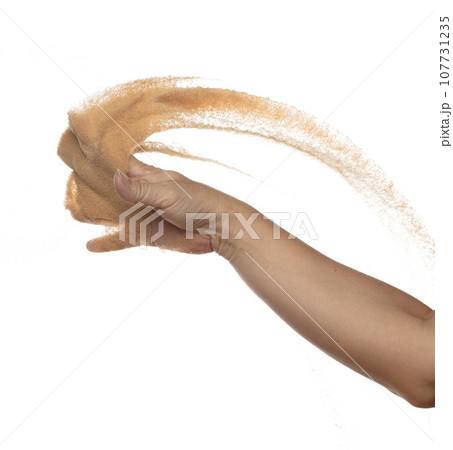 Hand throwing find sand in air. Arm wrist hand throw sand and splash explode through fingers and shape curve circle. Sand freeze stop freeze in Air. White background Isolated Hand throwing find sand in air. Arm wrist hand throw sand and splash explode through fingers and shape curve circle. Sand freeze stop freeze in Air. White background Isolated 107731235