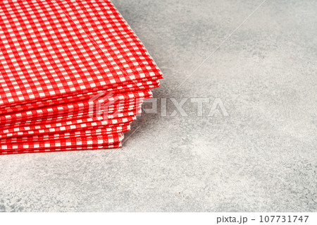 Stack of paper square napkins on gray background 107731747