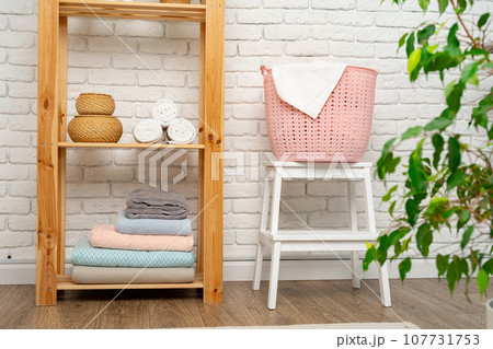 Pink plastic laundry basket in a bathroom 107731753