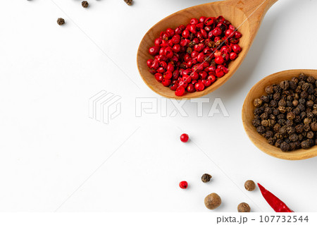 Wooden spoons with various spices isolated on white background Wooden spoons with various spices isolated on white background 107732544