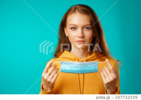 Young beautiful casual woman wearing protective medical mask Young beautiful casual woman wearing protective medical mask 107732559