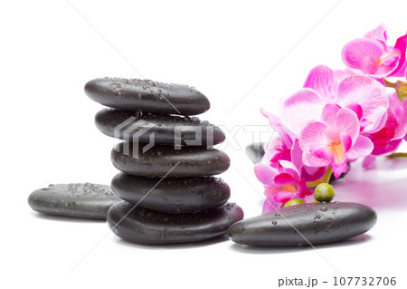 Spa stones and orchid flowers, isolated on white. Spa stones and orchid flowers, isolated on white. 107732706