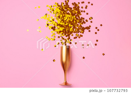 Champagne glass with confetti flat lay top view 107732793