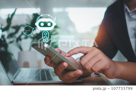 Businessman hand use show a smartphone to type live chat, ask, answer with an artificial intelligence system. chatbot. Ai assistant. 107733799