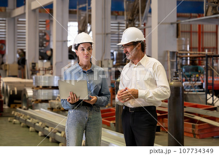 Factory manager or executive with his assistant visit factory tour. Exemplifying 107734349