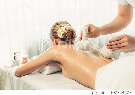 Hot herbal ball spa massage body treatment at day spa . Quiescent Hot herbal ball spa massage body treatment at day spa . Quiescent 107734578