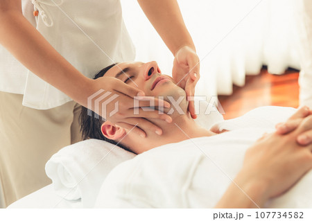 Caucasian man enjoying relaxing anti-stress head massage. Quiescent Caucasian man enjoying relaxing anti-stress head massage. Quiescent 107734582