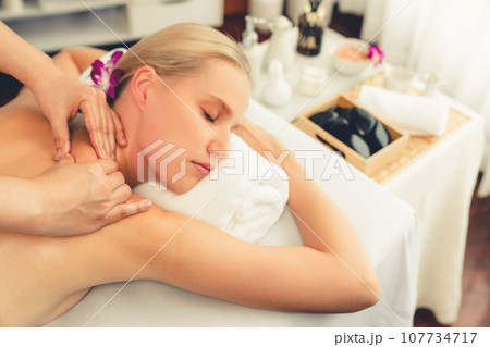 Caucasian woman customer enjoying relaxing anti-stress massage. Quiescent Caucasian woman customer enjoying relaxing anti-stress massage. Quiescent 107734717