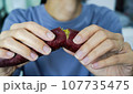 Asian woman is peeling Sweet Potatoes, closed up shot. 107735475