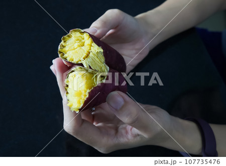 Asian woman is peeling Sweet Potatoes, closed up shot. 107735476