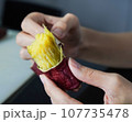 Asian woman is peeling Sweet Potatoes, closed up shot. 107735478