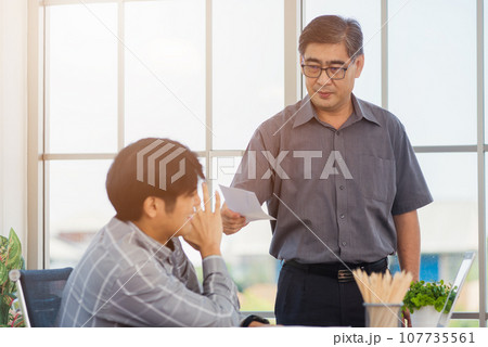 Asian businessman anti bribery and corruption he rejecting money in white envelope offered by partner. Business man sending resignation letter to employee the business downturn to laid off at office 107735561