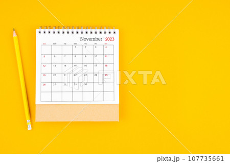 November2023 desk calendar and wooden pencil on yellow background. Time planning. 107735661