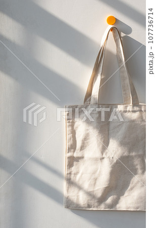 Textile shopping bag hanging from hook. Textile shopping bag hanging from hook. 107736714