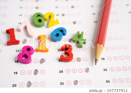 Math number and pencil on answer sheet paper, Education study testing learning teach concept. 107737912