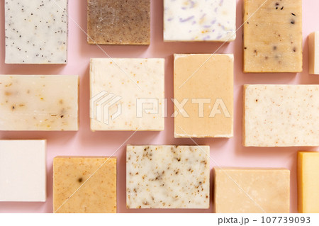 Beige and brown handmade soap bars on light pink top view. Natural herbal product for SPA 107739093