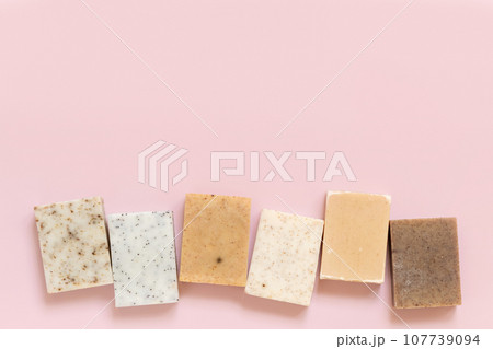 Beige and brown handmade soap bars on light pink top view. Natural herbal product for SPA Beige and brown handmade soap bars on light pink top view. Natural herbal product for SPA 107739094