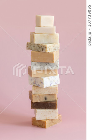 Beige handmade soap bars on light pink close up. Natural herbal product Beige handmade soap bars on light pink close up. Natural herbal product 107739095