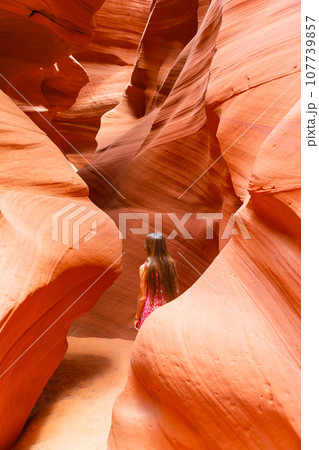 Young girl exploring Antilope Canyon in Arizona. Antilope canyon the most beautiful canyon in USA Young girl exploring Antilope Canyon in Arizona. Antilope canyon the most beautiful canyon in USA 107739857