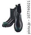 Beautiful pair of high demi-season boots made of black leather with a green spout, with a massive sole, isolated on a white background. 107740021