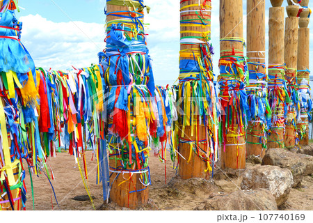 Hitching posts with ribbons of shamanism religion in Khuzhir, island Olkhon.  107740169