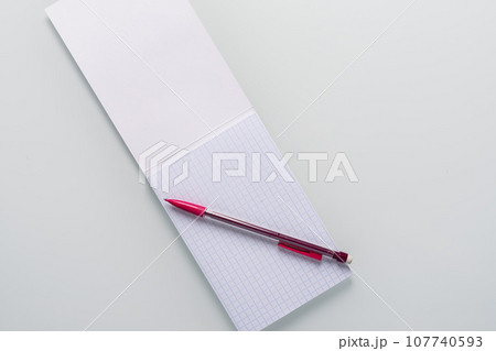 Top view of blank notebook with pencil on white background Top view of blank notebook with pencil on white background 107740593