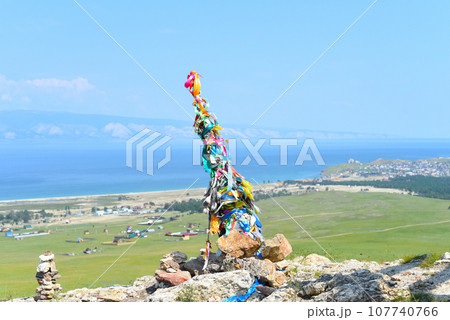 Hitching post with ribbons of shamanism religion in Khuzhir, island Olkhon. Hitching post with ribbons of shamanism religion in Khuzhir, island Olkhon. 107740766