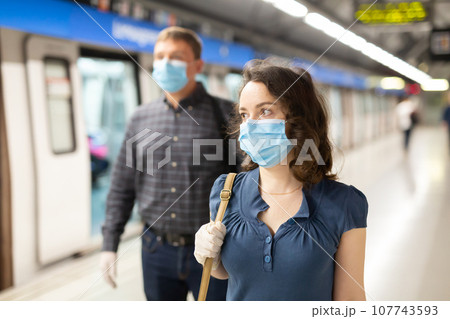 Metro passengers use personal protective Metro passengers use personal protective 107743593