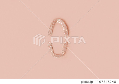 Transparent Dental Clear Aligners on Beige. Invisible Braces. Prevention Gum Treatment. Retainers for Dentistry Correction. Invisalign Orthodontics concept. Alignment of Teeth. Dentofacial Orthopedics Transparent Dental Clear Aligners on Beige. Invisible Braces. Prevention Gum Treatment. Retainers for Dentistry Correction. Invisalign Orthodontics concept. Alignment of Teeth. Dentofacial Orthopedics 107746248