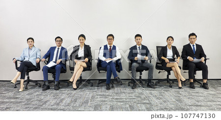 asian business people waiting in line for job interview looking at camera 107747130