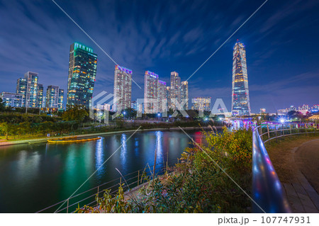 Night view in autumn and beautifully lit tourist boats at Songdo Central Park in Songdo District, Incheon South Korea. Night view in autumn and beautifully lit tourist boats at Songdo Central Park in Songdo District, Incheon South Korea. 107747931