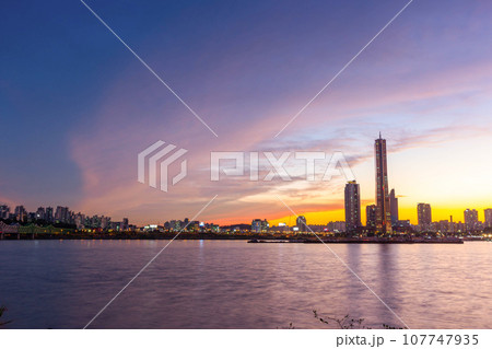 View beside the Han River overlooking the skyscrapers at Yeouido after sunset, South Korea. View beside the Han River overlooking the skyscrapers at Yeouido after sunset, South Korea. 107747935