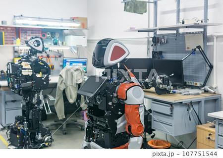 humanoid robots in the process of assembly and adjustment in the workshop humanoid robots in the process of assembly and adjustment in the workshop 107751544