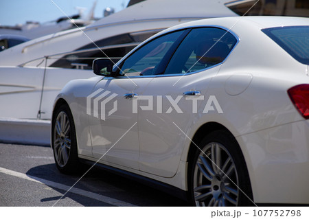 Close up of a white sport car parked in the marina. 107752798