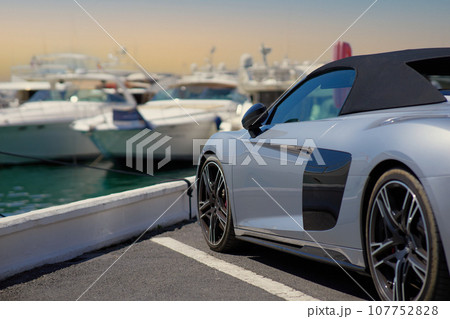 Luxury sports car on the background of yachts. 107752828