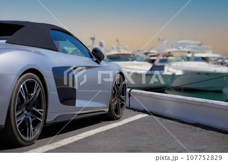 Luxury sports car on the background of yachts. 107752829
