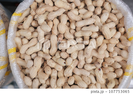 peeled peanuts in a bowl on table peeled peanuts in a bowl on table 107753065