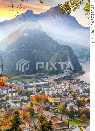 Exciting autumn view on suburb of Stansstad city and Lucerne lake with mountaines and fog 107753384