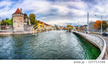 Fabulous historic city center of Lucerne with famous buildings and calm waters of Reuss river. Fabulous historic city center of Lucerne with famous buildings and calm waters of Reuss river. 107753386