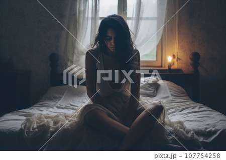 Young woman seating on the bed feeling sad, worried, suffering depression in mental health Young woman seating on the bed feeling sad, worried, suffering depression in mental health 107754258