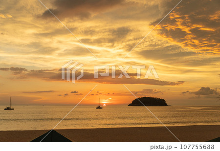 .beautiful cloud in golden sky at sunset in Kata beach Phuket Thailand. 107755688