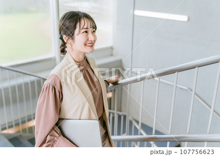 オフィスの階段を登る女性・ビジネスウーマン(朝・出社・通勤) オフィスの階段を登る女性・ビジネスウーマン(朝・出社・通勤) 107756623